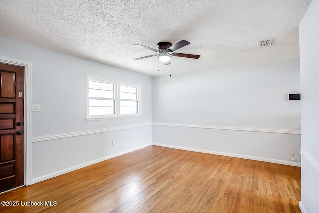504 53rd St, Lubbock, TX 79404 - unfurnished room featuring a ceiling fan, hardwood / wood-style floors, and a textured ceiling