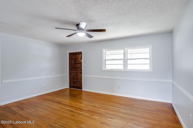 504 53rd St, Lubbock, TX 79404 - spare room with a textured ceiling, a ceiling fan, and wood finished floors