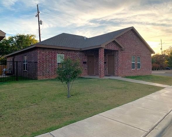 ranch-style house with a lawn