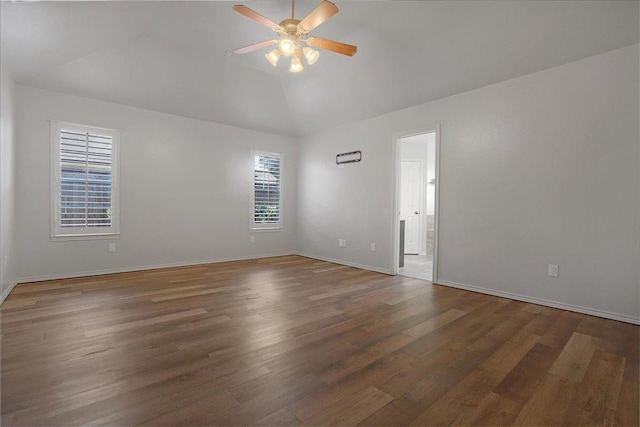 unfurnished room featuring dark hardwood / wood-style flooring, vaulted ceiling, and ceiling fan