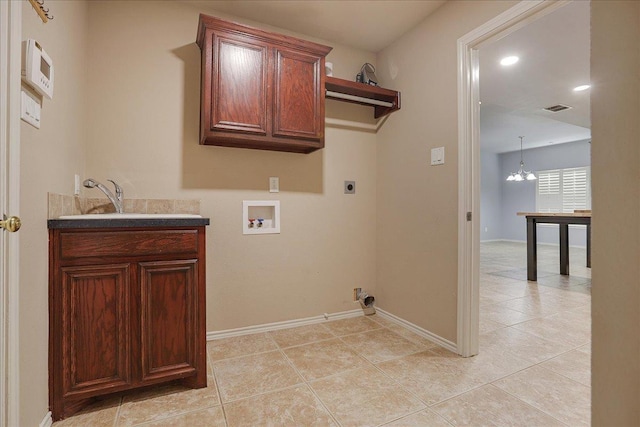 washroom featuring sink, cabinets, a chandelier, hookup for a washing machine, and electric dryer hookup