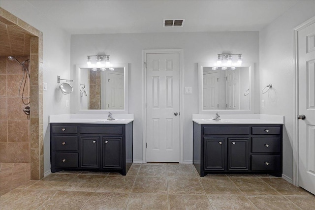 bathroom with vanity and tiled shower