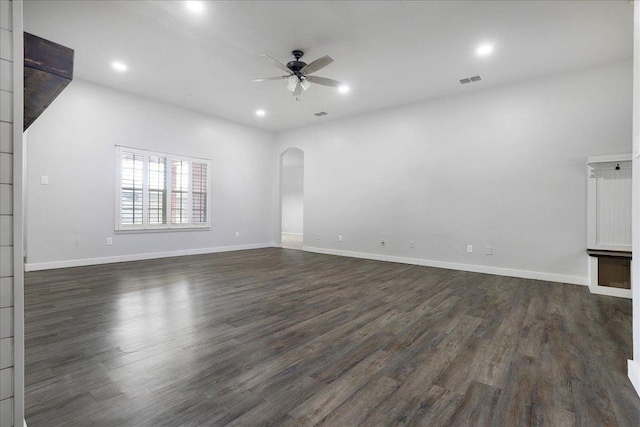 empty room with ceiling fan and dark hardwood / wood-style flooring