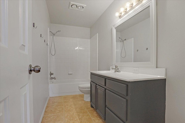 full bathroom featuring vanity, tile patterned flooring, tiled shower / bath combo, and toilet