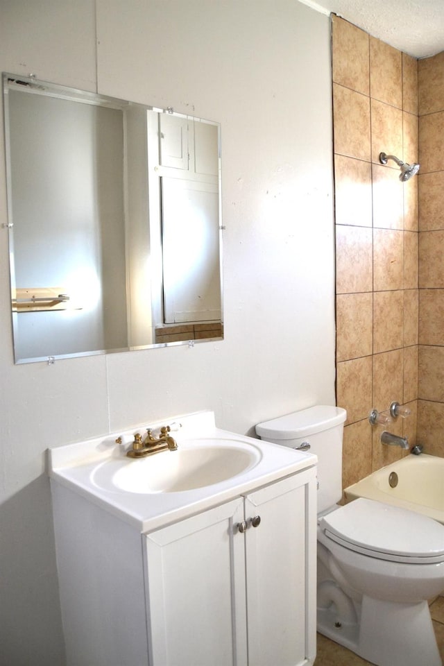 full bathroom with vanity, tiled shower / bath combo, a textured ceiling, and toilet