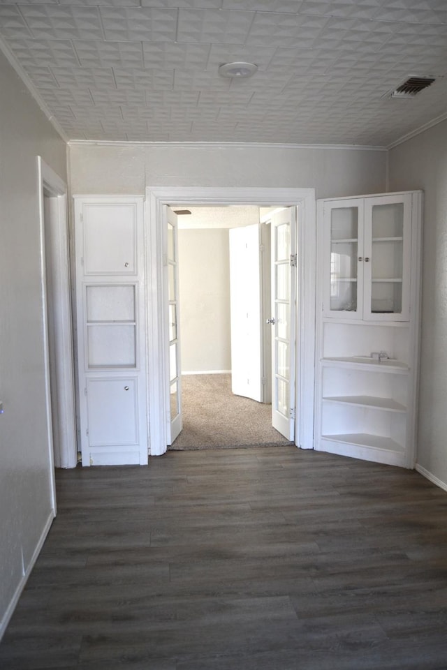 corridor with crown molding and dark hardwood / wood-style floors