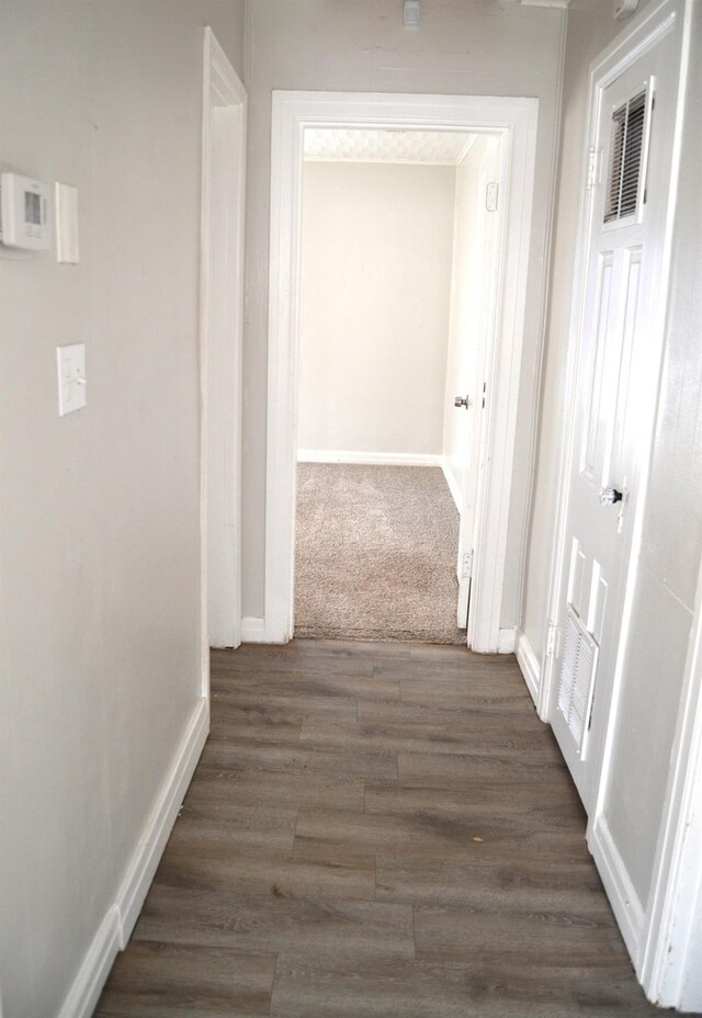 hallway featuring dark hardwood / wood-style flooring