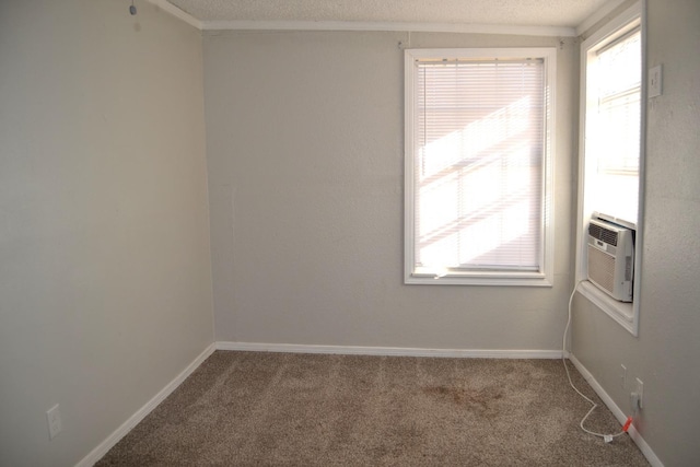 unfurnished room with cooling unit, a textured ceiling, and carpet flooring