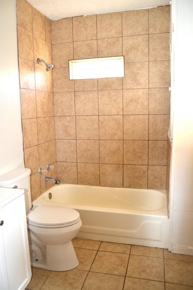 full bathroom with tile patterned flooring, vanity, tiled shower / bath combo, and toilet