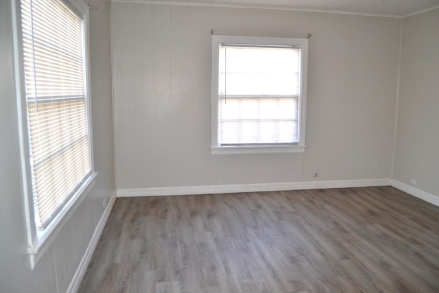 unfurnished room with crown molding and light hardwood / wood-style floors