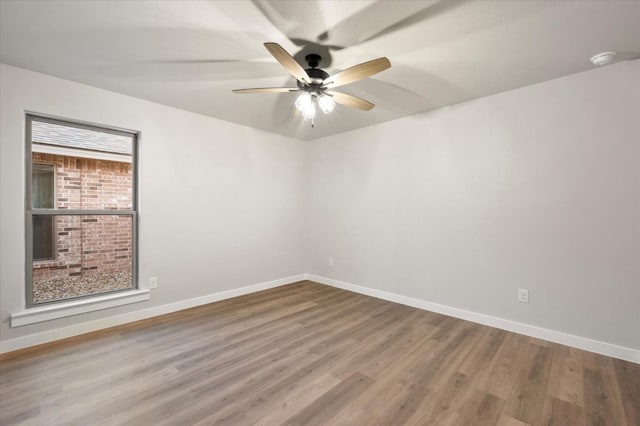 unfurnished room with hardwood / wood-style flooring and ceiling fan