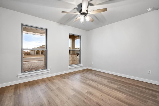 spare room featuring ceiling fan and light hardwood / wood-style floors