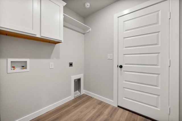 laundry room with cabinets, light hardwood / wood-style floors, hookup for a washing machine, and electric dryer hookup