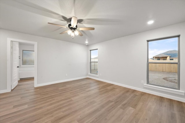 empty room featuring ceiling fan and light hardwood / wood-style floors