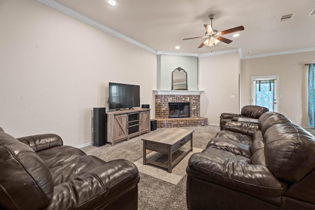 living room featuring a fireplace, ornamental molding, light colored carpet, and ceiling fan