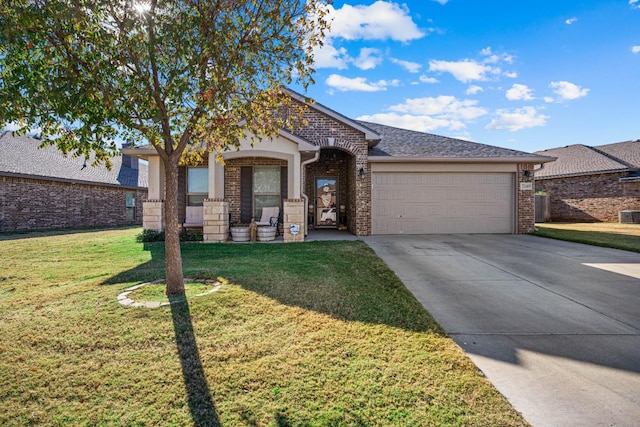 view of front of property featuring a garage, a front yard, and central air condition unit