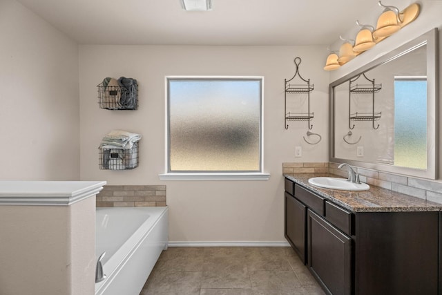 bathroom with vanity and a washtub