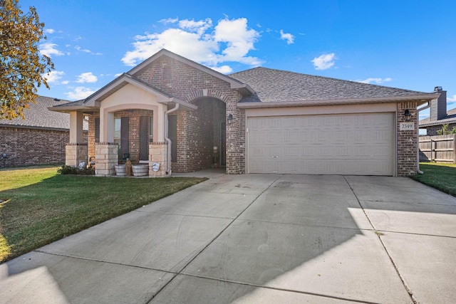 view of front of home featuring a garage and a front lawn