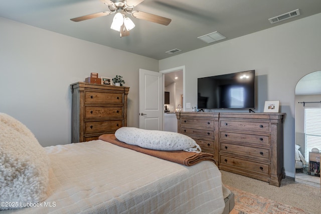 7511 31st St, Lubbock, TX 79407 - bedroom with light carpet, a ceiling fan, and arched walkways