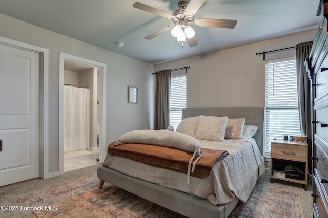 7511 31st St, Lubbock, TX 79407 - carpeted bedroom with multiple windows, ensuite bath, and ceiling fan