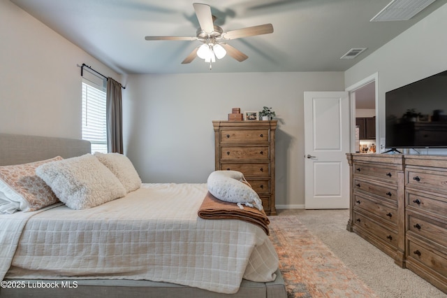 7511 31st St, Lubbock, TX 79407 - bedroom with light carpet and a ceiling fan