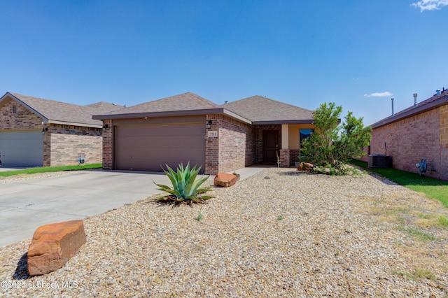7511 31st St, Lubbock, TX 79407 - view of front of house with brick siding, an attached garage, concrete driveway, and roof with shingles