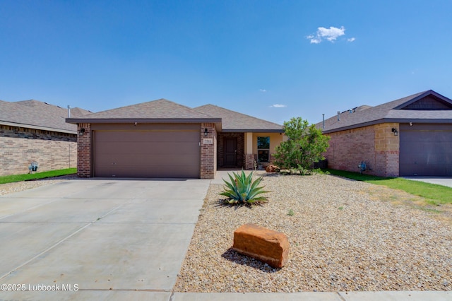 7511 31st St, Lubbock, TX 79407 - ranch-style home with brick siding, an attached garage, and driveway