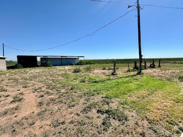 view of yard with a rural view