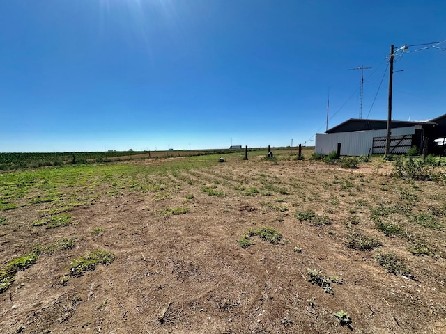 view of yard featuring an outbuilding and a rural view