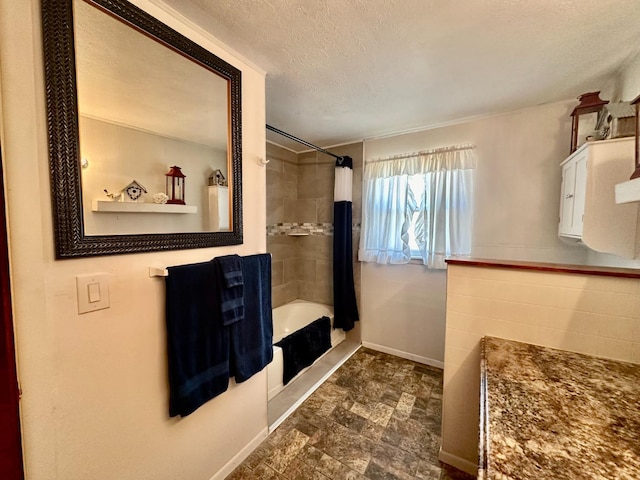 bathroom featuring a textured ceiling and shower / bath combo with shower curtain