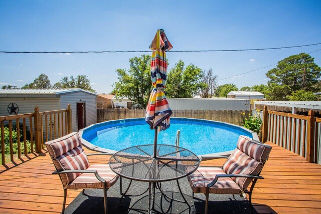 view of swimming pool with a deck