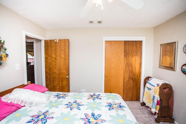 bedroom with carpet flooring, ceiling fan, and a closet