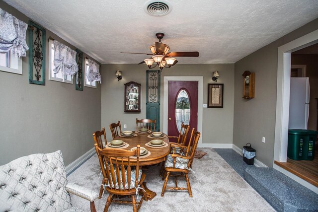 dining room with ceiling fan and a textured ceiling