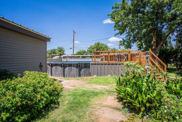 view of yard with a pool side deck