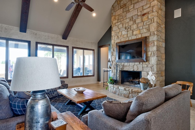 living room featuring beamed ceiling, a stone fireplace, plenty of natural light, and high vaulted ceiling