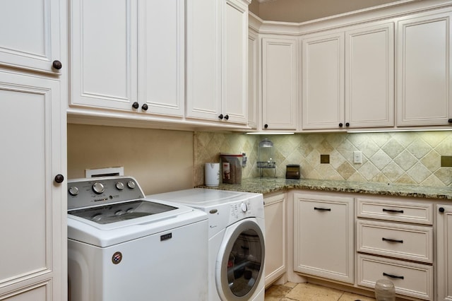 washroom featuring separate washer and dryer and cabinets