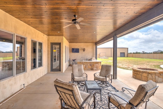 view of patio / terrace with a bar and ceiling fan