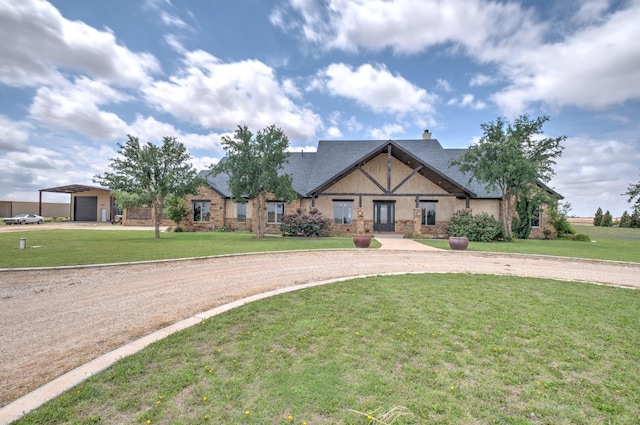 view of front of home with a garage, an outdoor structure, and a front yard