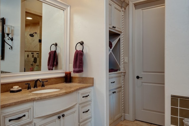 bathroom featuring vanity and tiled shower