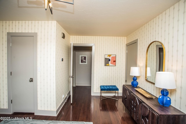 4609 10th St, Lubbock, TX 79416 - corridor featuring dark wood-type flooring, wallpapered walls, and baseboards