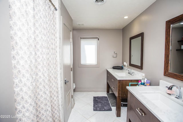 4609 10th St, Lubbock, TX 79416 - full bath with two vanities, toilet, tile patterned floors, a shower with shower curtain, and baseboards