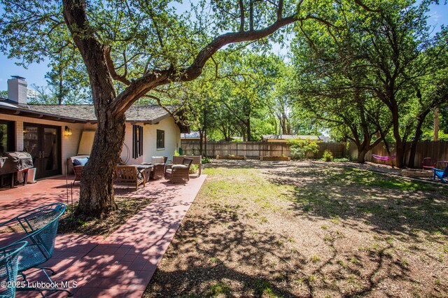 4609 10th St, Lubbock, TX 79416 - fenced backyard featuring outdoor lounge area and a patio area