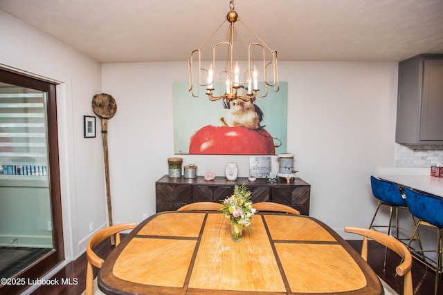 4609 10th St, Lubbock, TX 79416 - dining area featuring a chandelier, wood finished floors, and baseboards