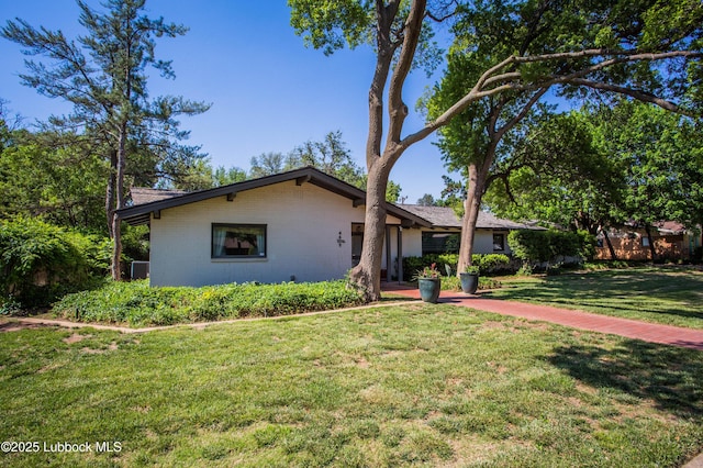 4609 10th St, Lubbock, TX 79416 - view of front facade with a front lawn and brick siding