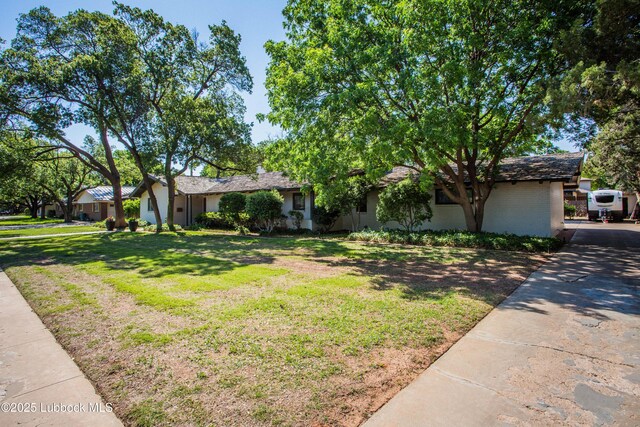 4609 10th St, Lubbock, TX 79416 - view of front of house featuring a front lawn and brick siding