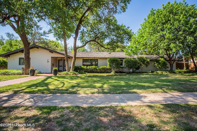 4609 10th St, Lubbock, TX 79416 - view of front facade featuring a front lawn and stucco siding