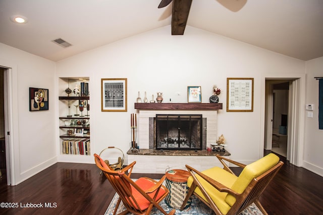 4609 10th St, Lubbock, TX 79416 - living room featuring wood finished floors, ceiling fan, baseboards, built in features, and a fireplace