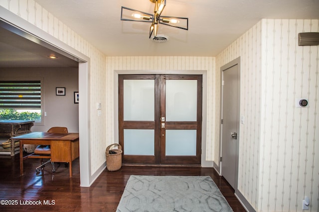 4609 10th St, Lubbock, TX 79416 - entryway featuring dark wood-style floors, wallpapered walls, and baseboards