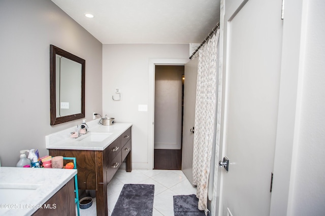 4609 10th St, Lubbock, TX 79416 - full bath featuring vanity, tile patterned floors, and a shower with shower curtain