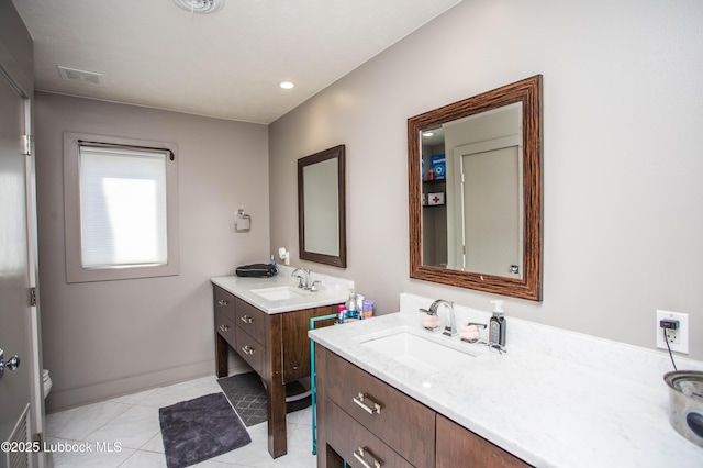 4609 10th St, Lubbock, TX 79416 - bathroom with two vanities, tile patterned flooring, baseboards, and toilet